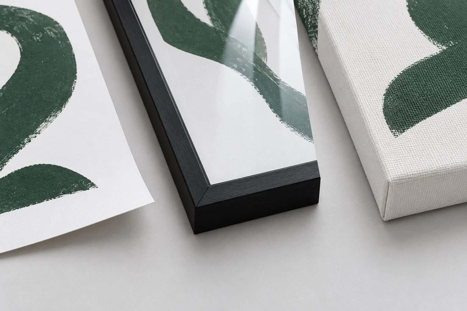 Illustrative close-up of matte paper, a glazed wood frame corner and wrapped canvas texture